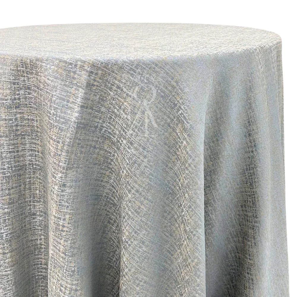 Silver Blue with Sand Jacquard Round Tablecloth, elegantly draped over a round table, showcasing intricate fabric texture, perfect for upscale events by Party Social.