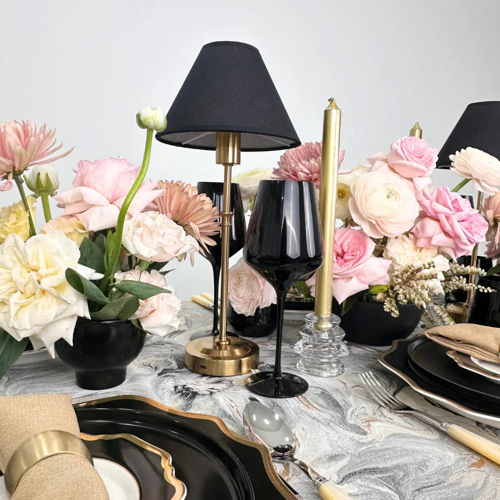 Black with Gold Base Wireless Lamp on a table, surrounded by flowers and candles, showcasing a stylish and durable design for events.