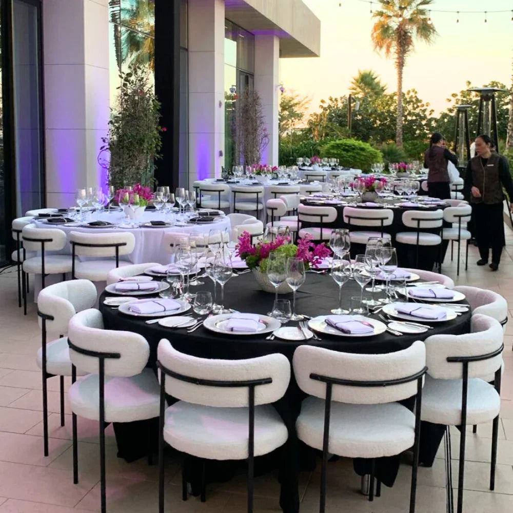 BOUCLE CHAIRS arranged for a stylish event setting, featuring modern design and black legs, ideal for weddings and corporate functions.