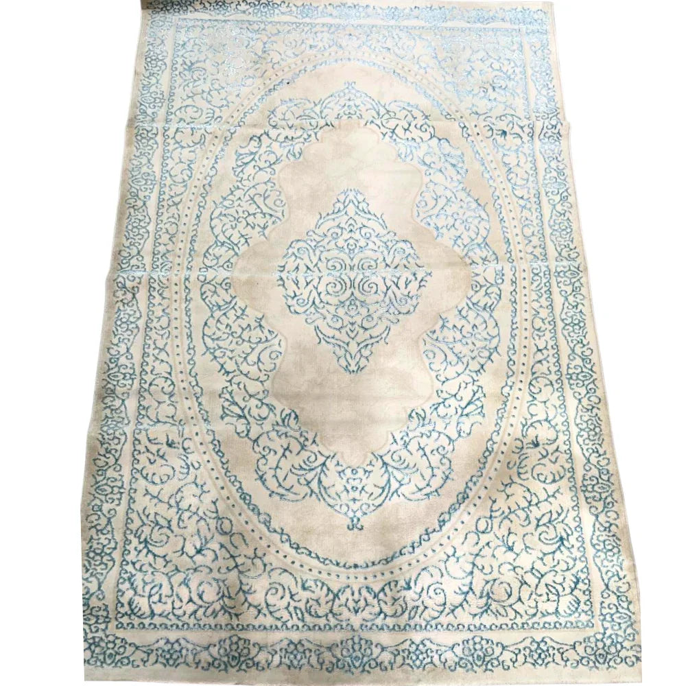 RUG TURQUOISE SWIRL: Elegant area rug with scrolling floral pattern and central medallion, perfect for adding sophistication to events.