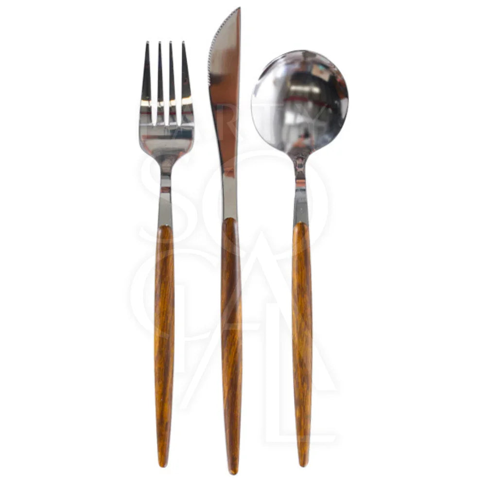 CUTLERY WOODEN SILVER close-up showing a knife, fork, and tool with wooden handles, ideal for adding a dramatic touch to any dinner setting.