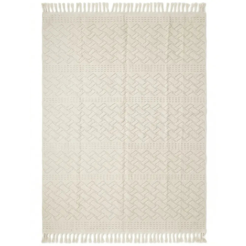 RUG GEOMETRIC NATURAL WOVEN: Cream-colored woven textile with a herringbone pattern and fringe, suitable as a decorative throw or small area rug for events.