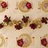 Vintage Arabesque - Dining Setup featuring a table for eight with gold plates, silverware, juice glasses, flower centerpieces, and ghost chairs, ideal for elegant events.