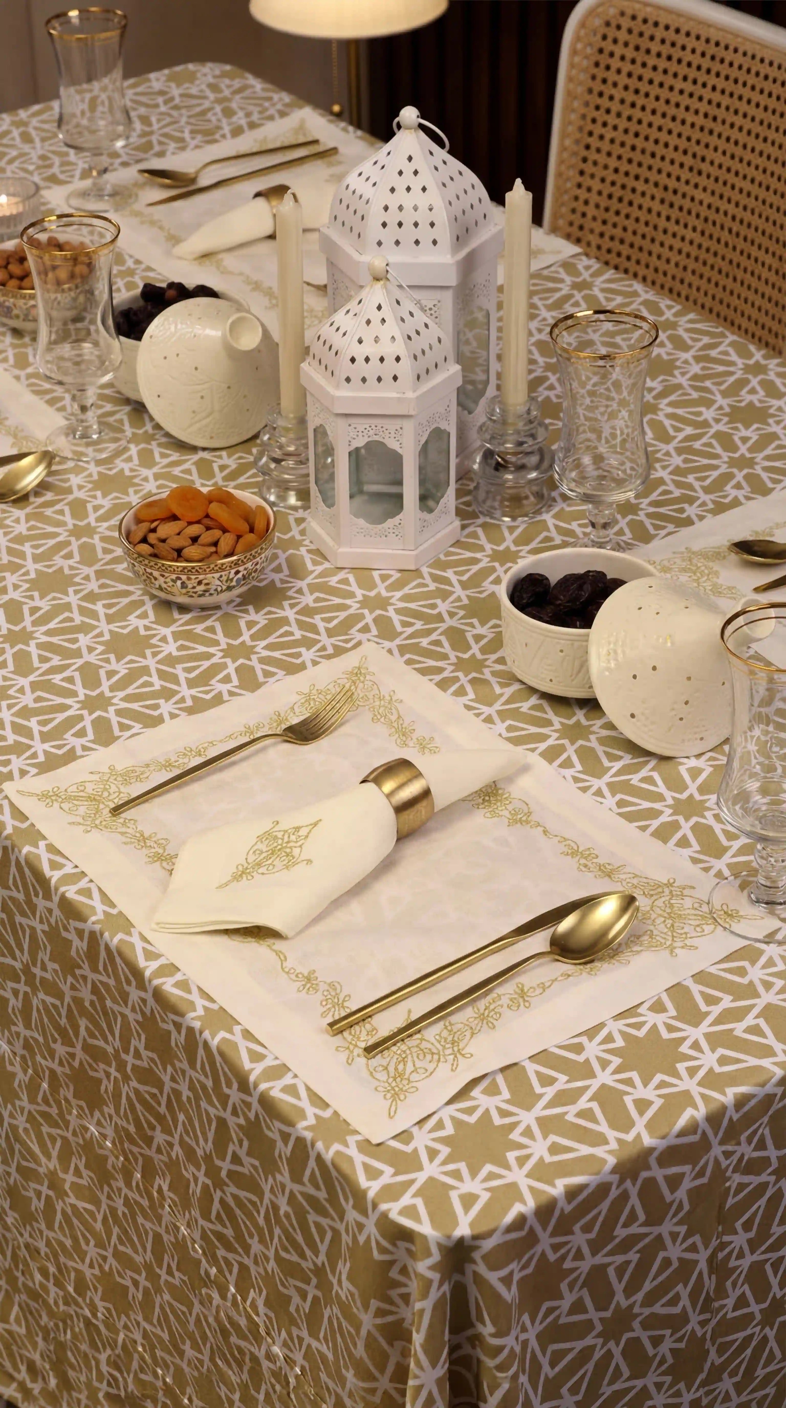 Sahara Geo Linen Tablecloth with white geometric pattern on a beige background, elegantly set with gold accents and white lantern centerpiece for a refined dining experience.