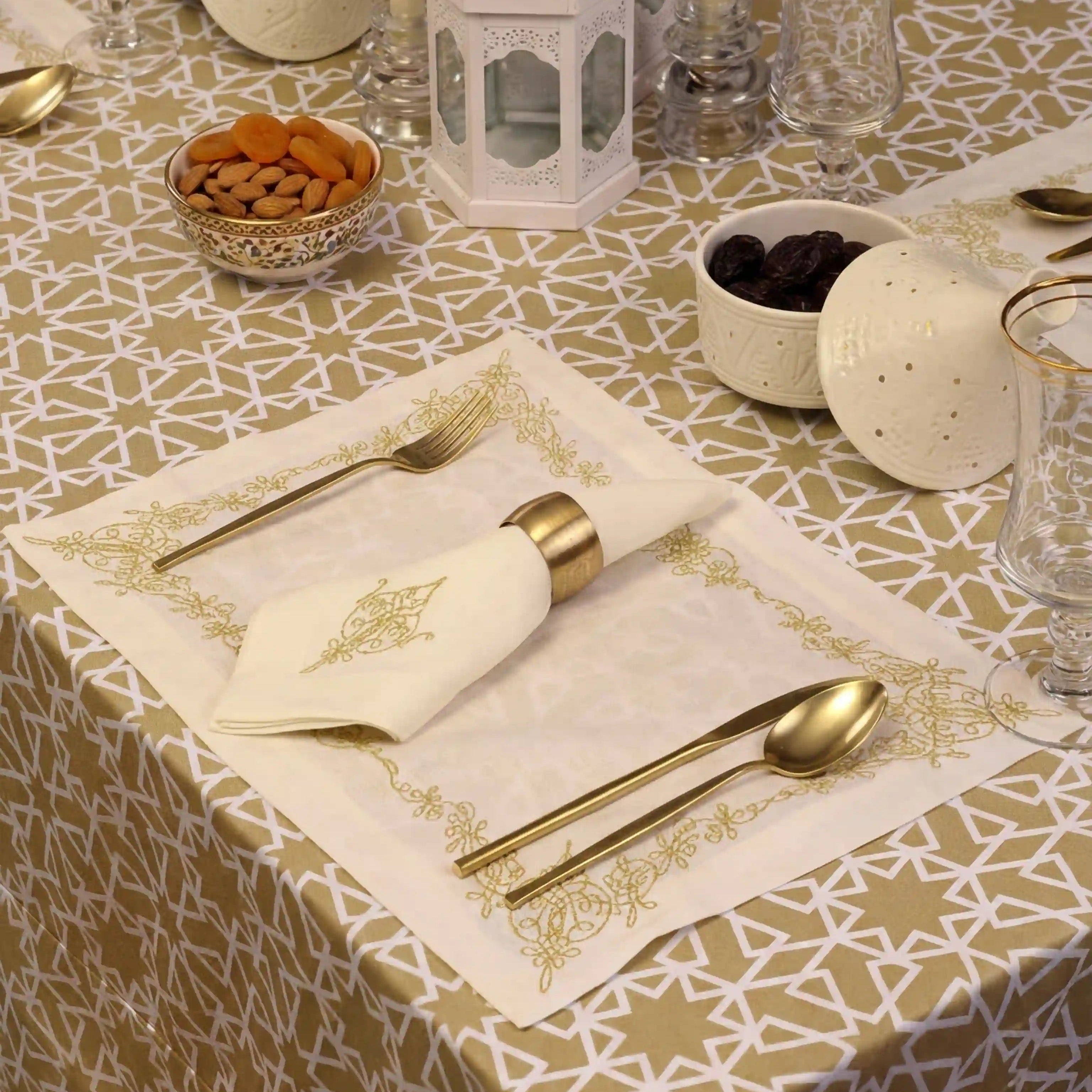Sahara Geo Linen Tablecloth with white geometric pattern on a beige background, elegantly set with gold accents and white lantern centerpiece for a refined dining experience.