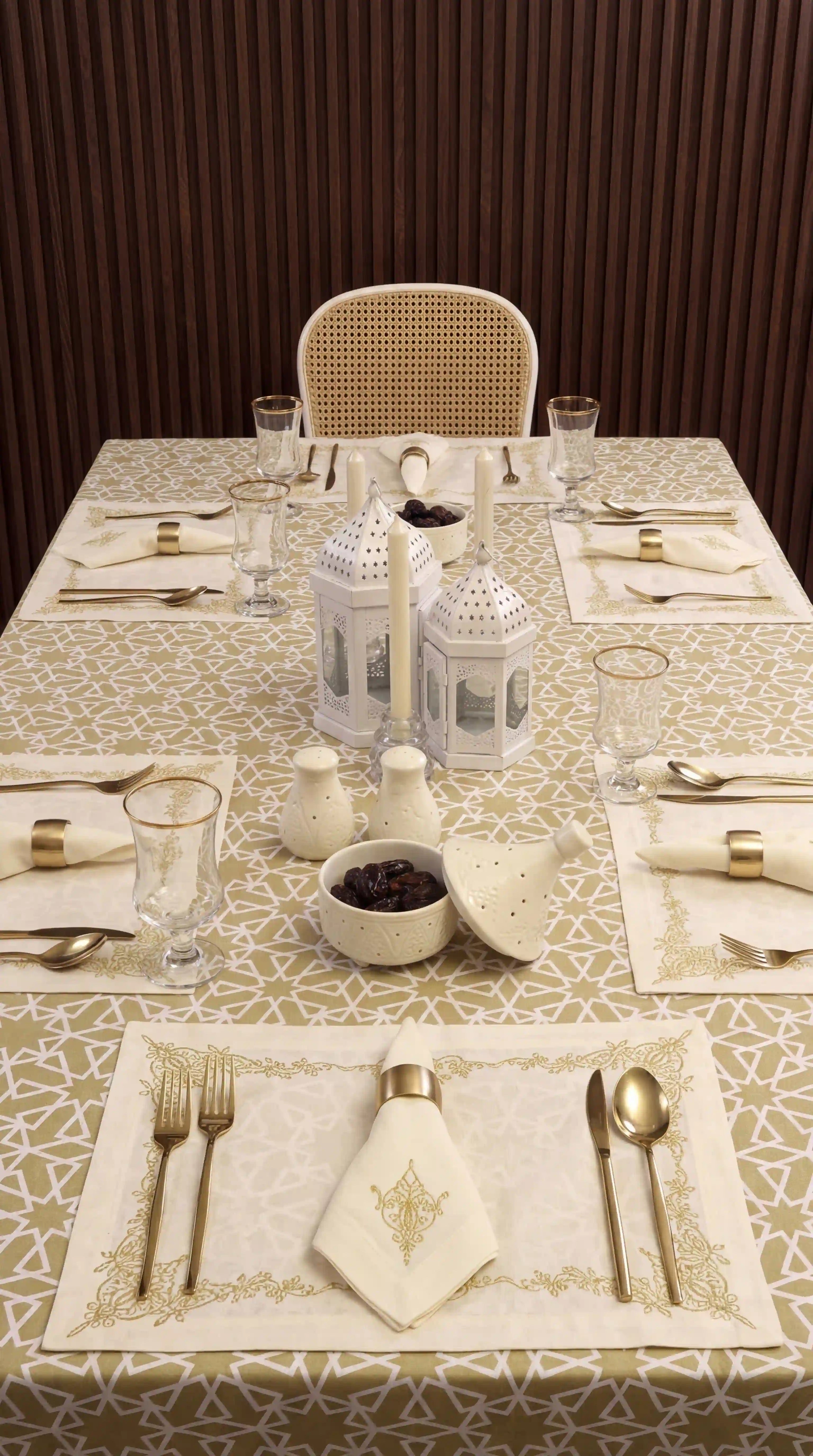 Sahara Geo Linen Tablecloth elegantly drapes a dining table, enhancing a refined table setting with gold accents, lanterns, and candles, ideal for sophisticated events.