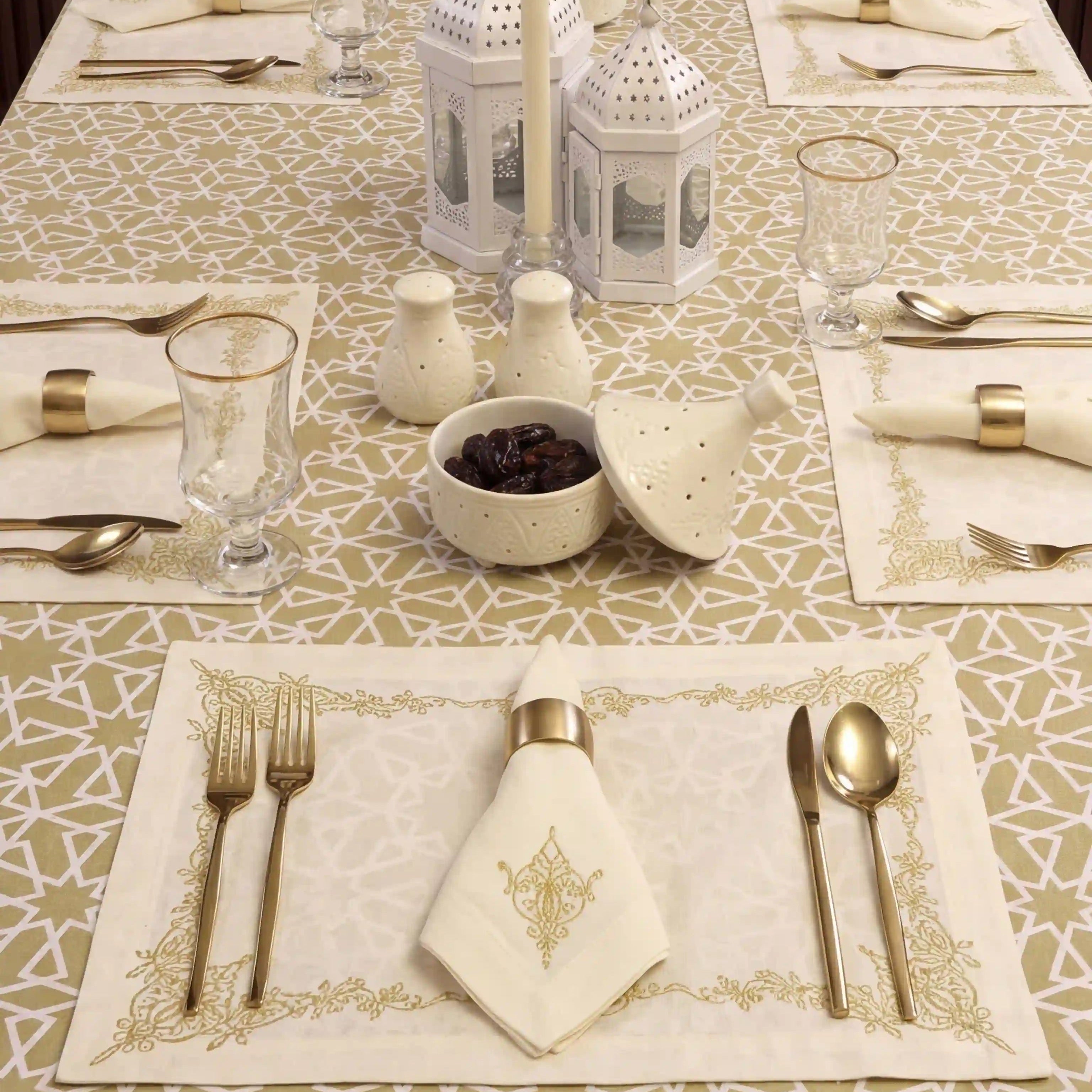 Sahara Geo Linen Tablecloth elegantly drapes a dining table, enhancing a refined table setting with gold accents, lanterns, and candles, ideal for sophisticated events.