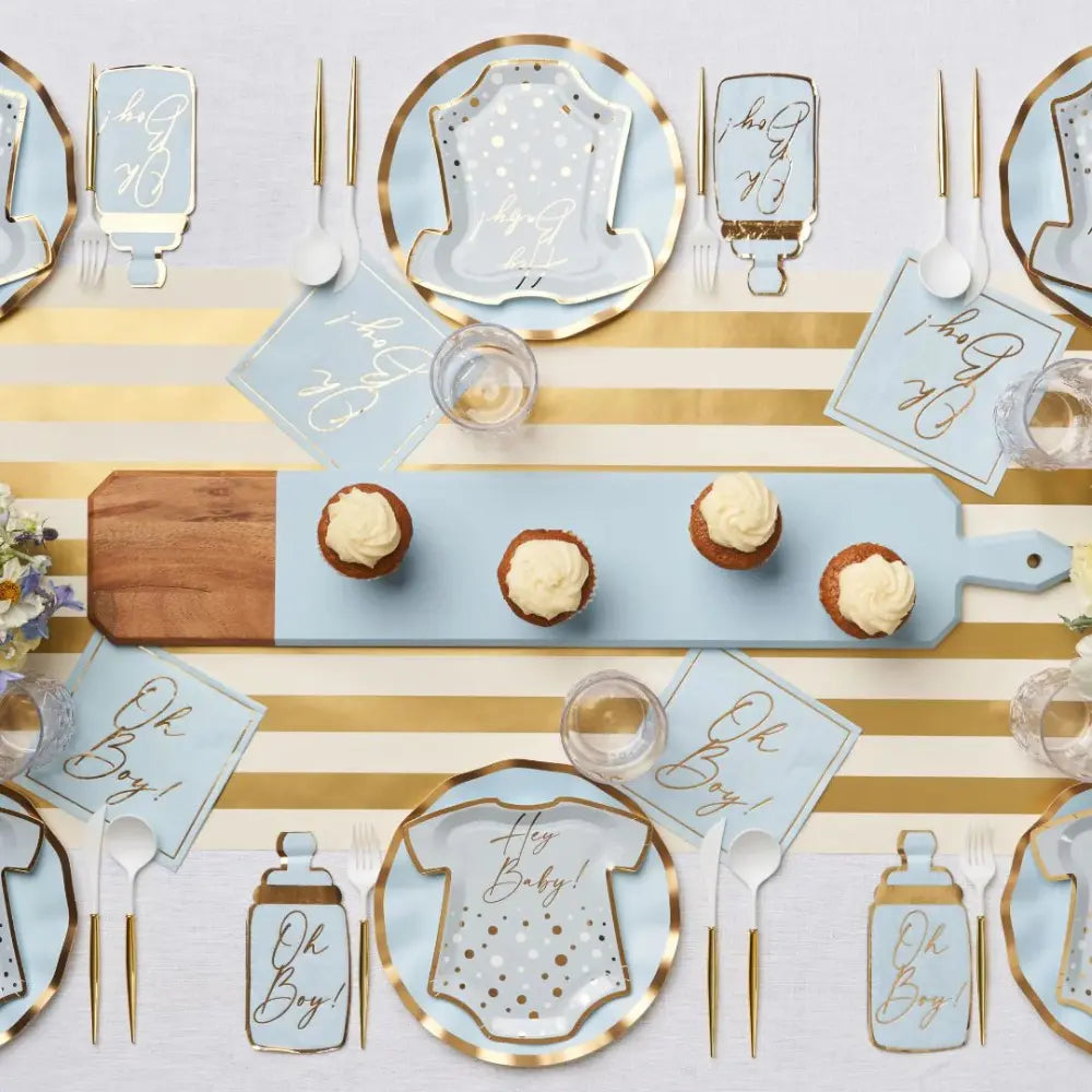Styled baby-shower table with Everyday Sky Blue Dinner Plates featuring a onesie graphic and Hey Baby! among matching Oh Boy! napkins and gold accents.