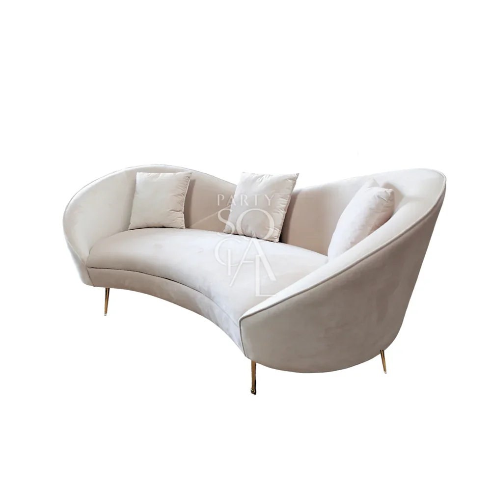 KOSHA SAND VELVET SOFA with plush white pillows, featuring modern velvet design and wooden legs, ideal for elegant lounge seating.