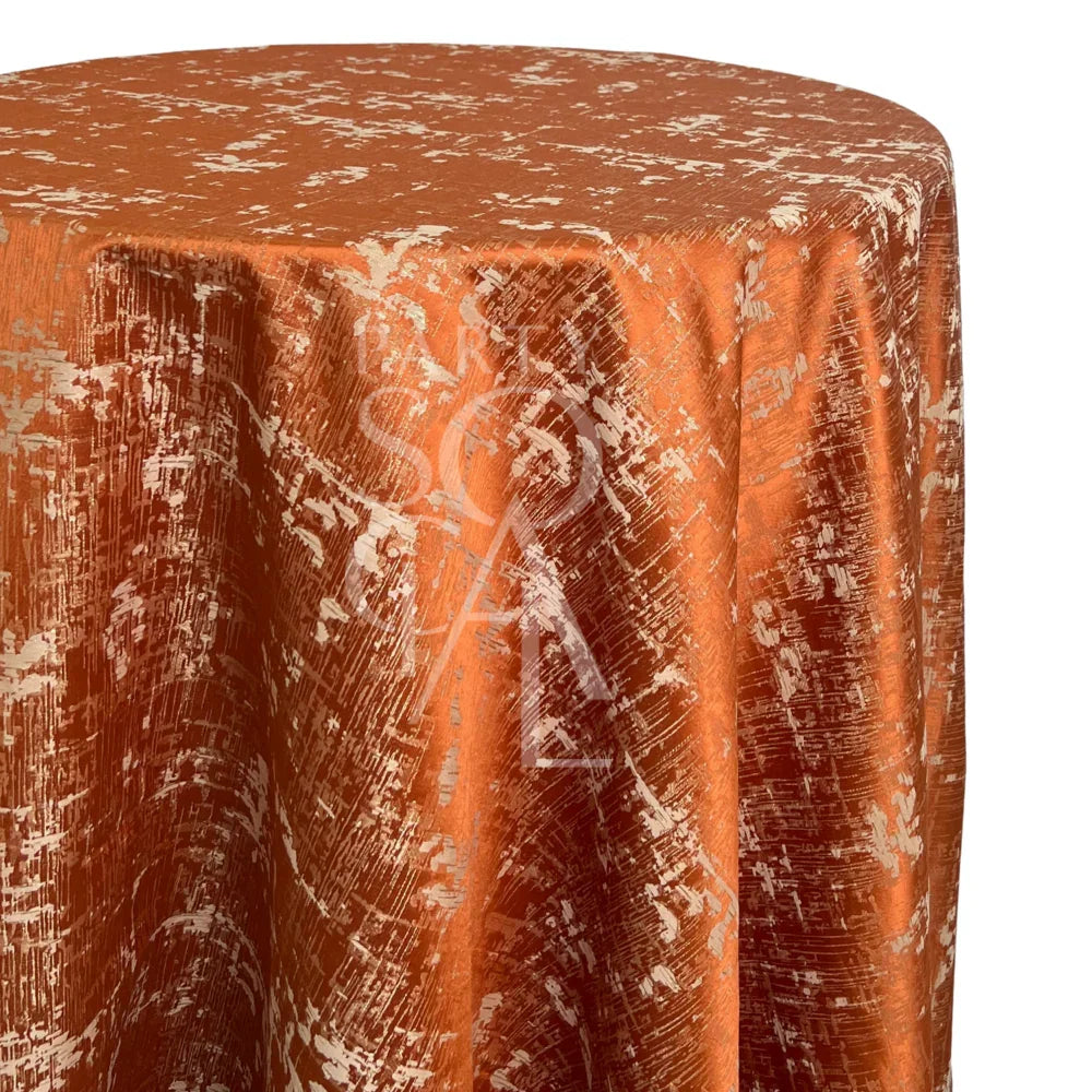 Burnt Orange Jacquard Round Tablecloth with metallic accents and distressed pattern, perfect for creating an artful centerpiece at intimate dinners or autumnal gatherings.