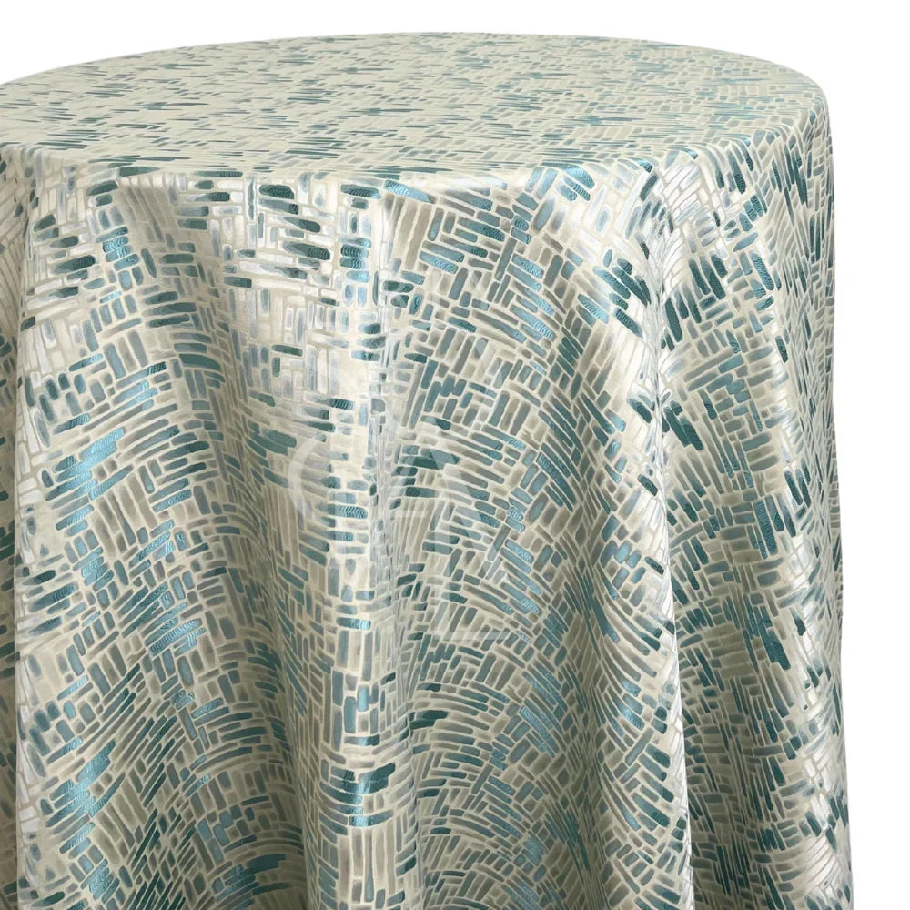 Blue Mosaic Round Tablecloth with abstract brush-stroke pattern in teal and off-white, ideal for coastal-themed events and weddings, enhancing any party setting.