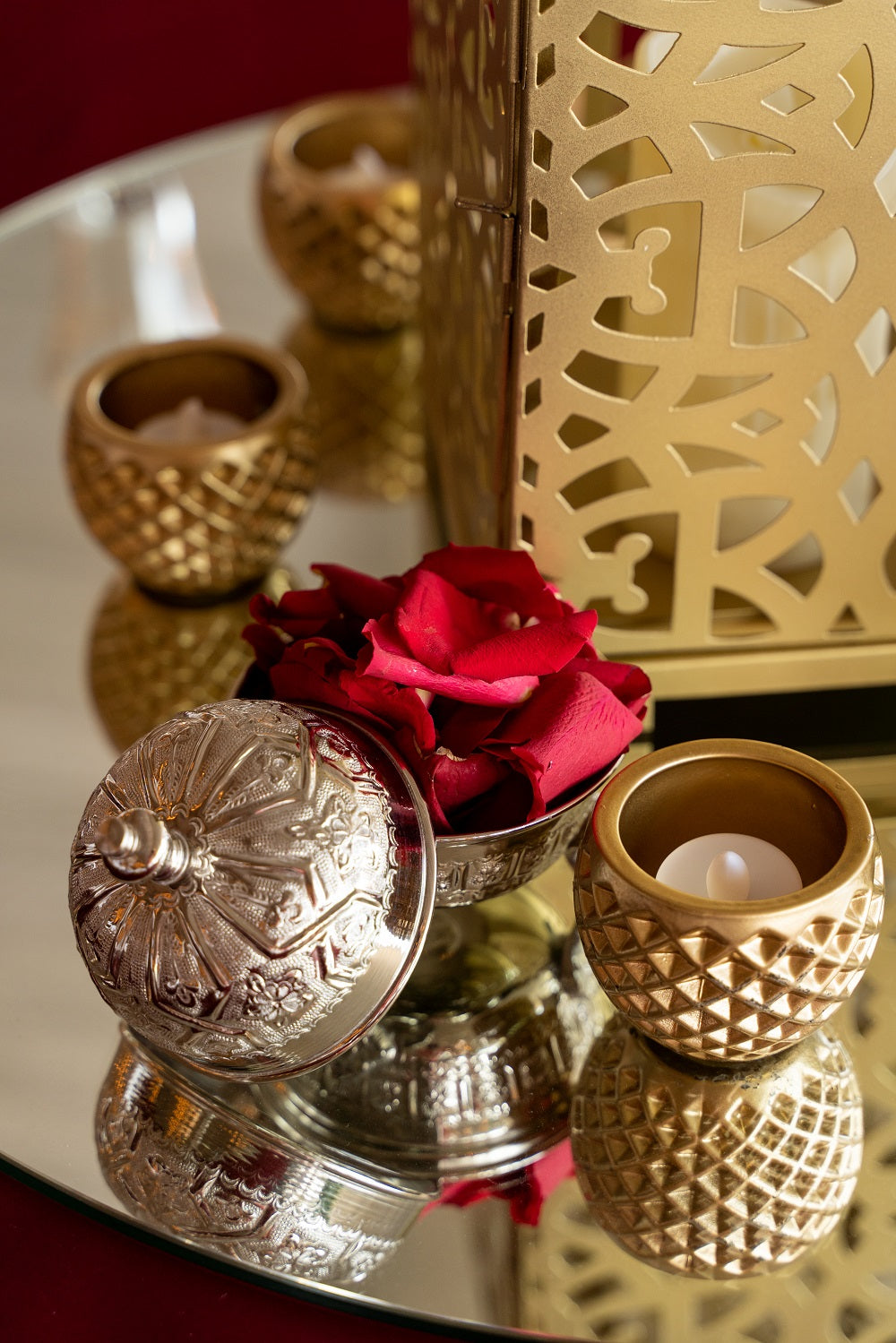 Crystal Tea Light Candle Holder displayed with a rose in a silver bowl and a candle, emphasizing its use in elegant event settings. Candles sold separately.