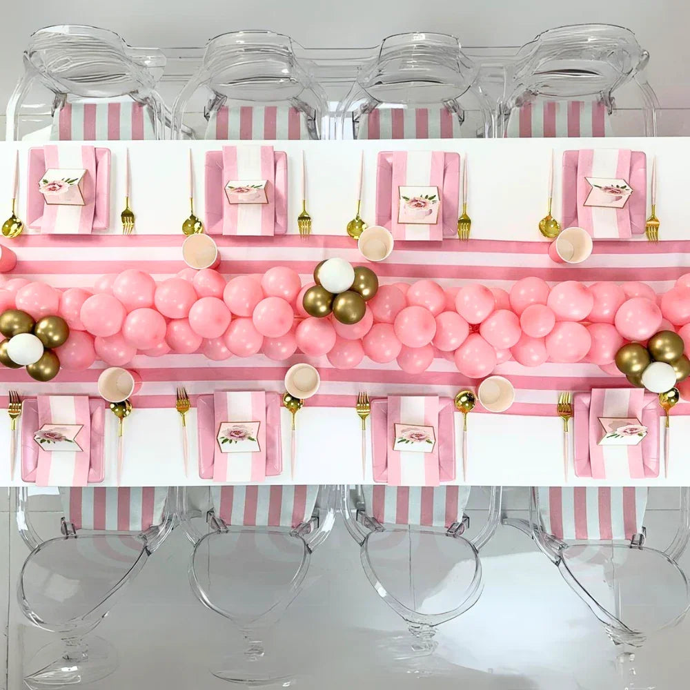 Pink Balloon Runner on a table setup, featuring pink and white striped napkins and clear chairs, ideal for kids&