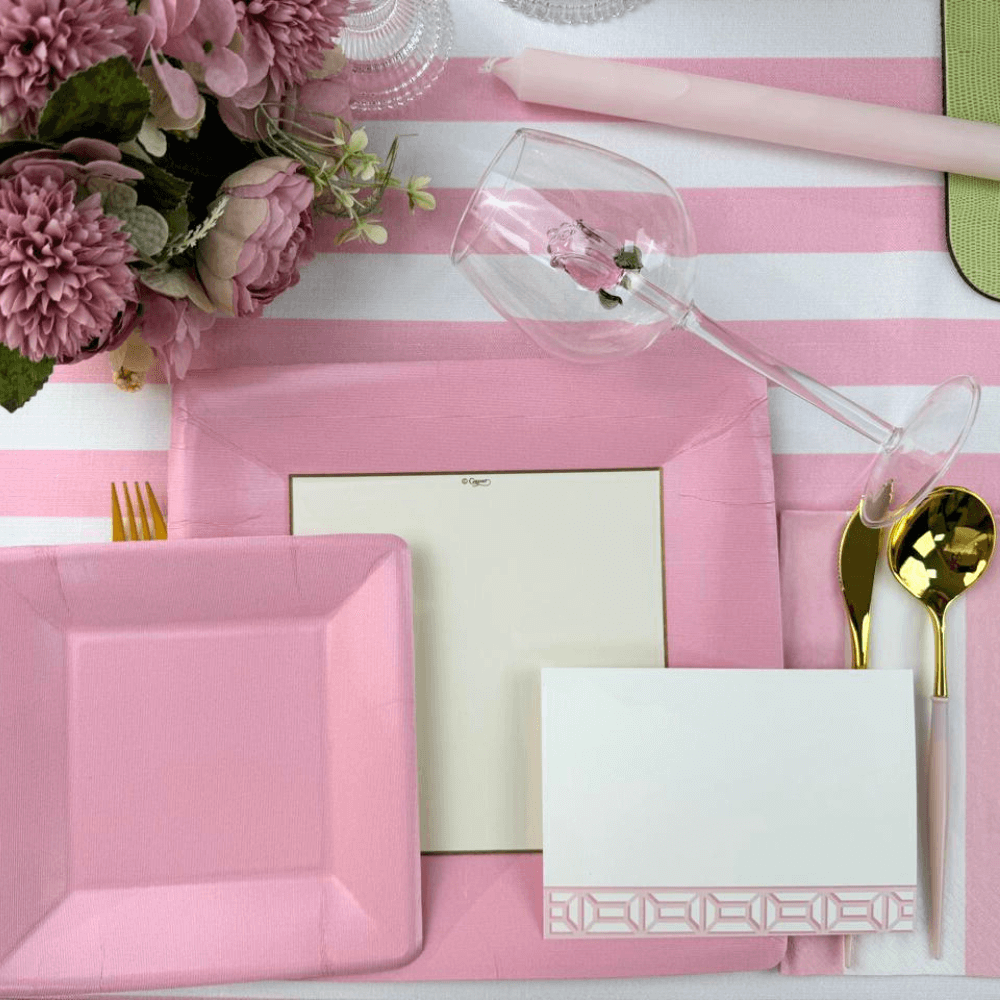 Alt text: Grosgrain Square Paper Salad & Dessert Plates in Light Pink - 8 Per Package, elegantly set on a pink and white table with floral accents.