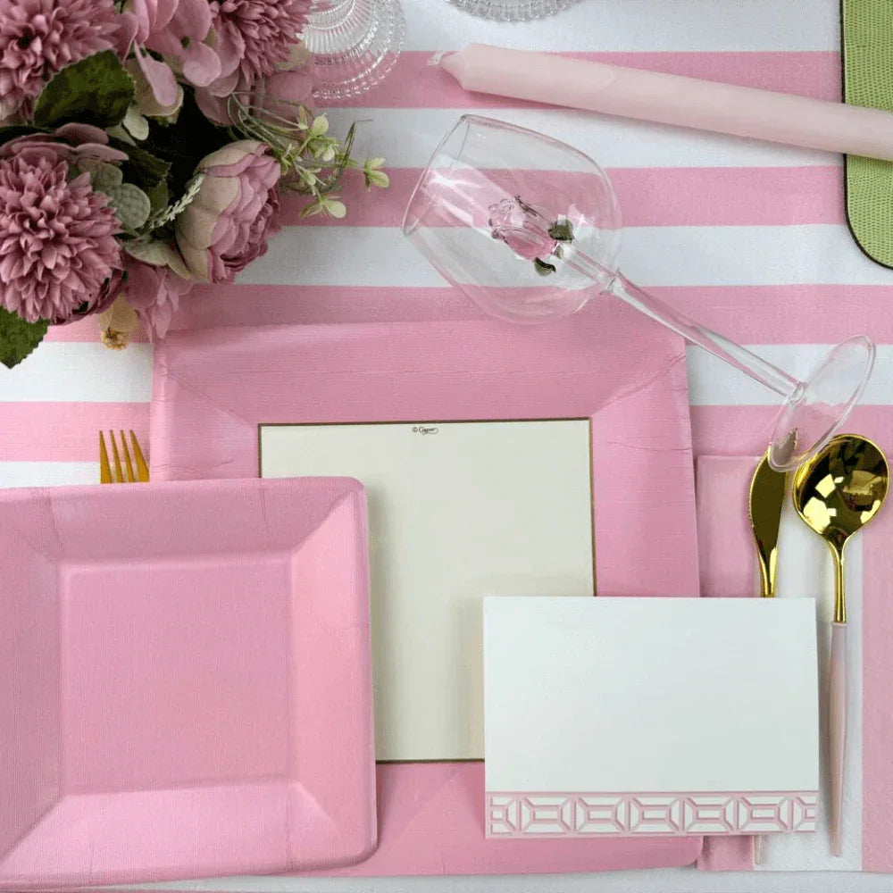 Alt text: Grosgrain Square Paper Salad & Dessert Plates in Light Pink - 8 Per Package, elegantly set on a pink and white table with floral accents.