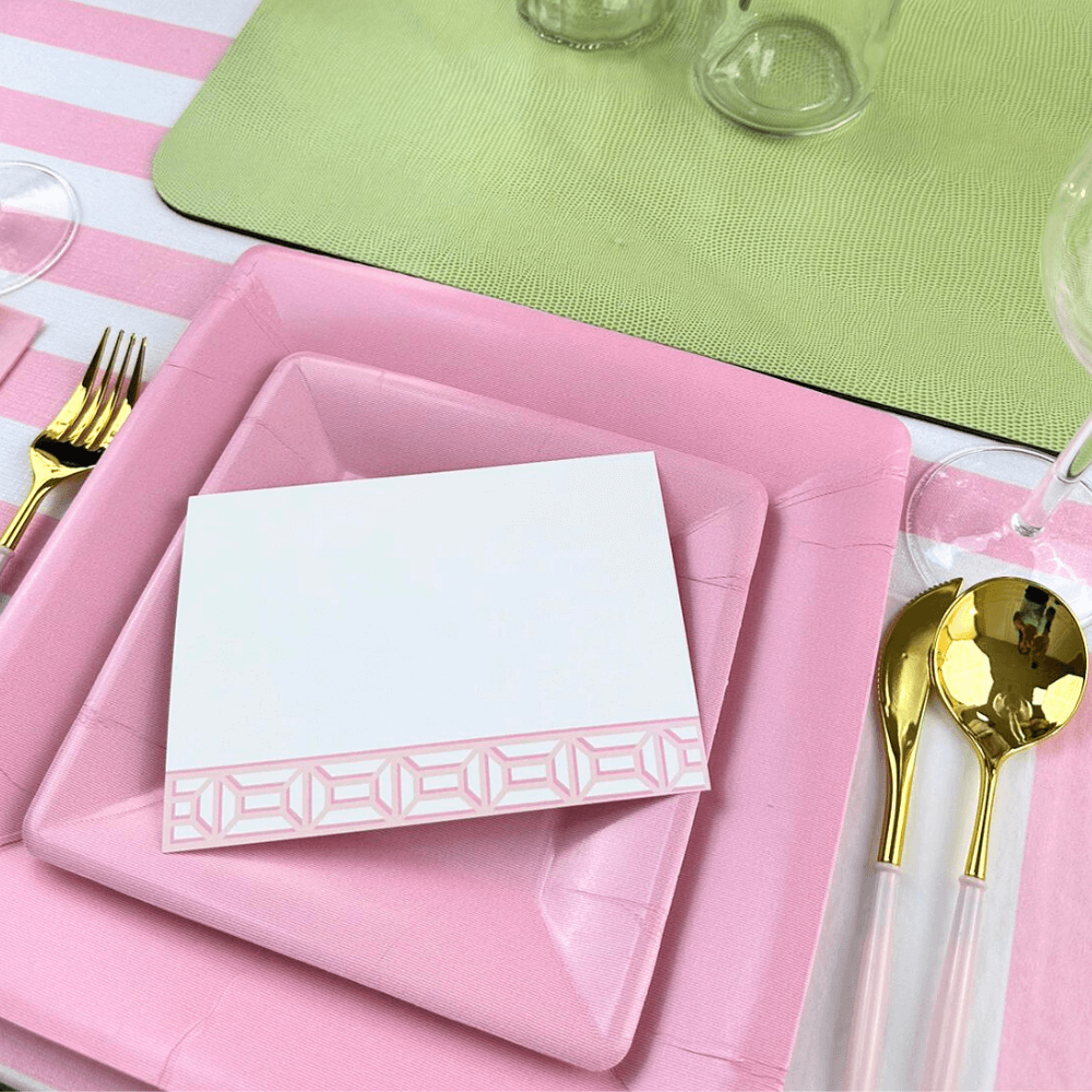 Grosgrain Square Paper Salad & Dessert Plates in Light Pink - 8 Per Package, displayed with a white card on top, fork, and spoon nearby.