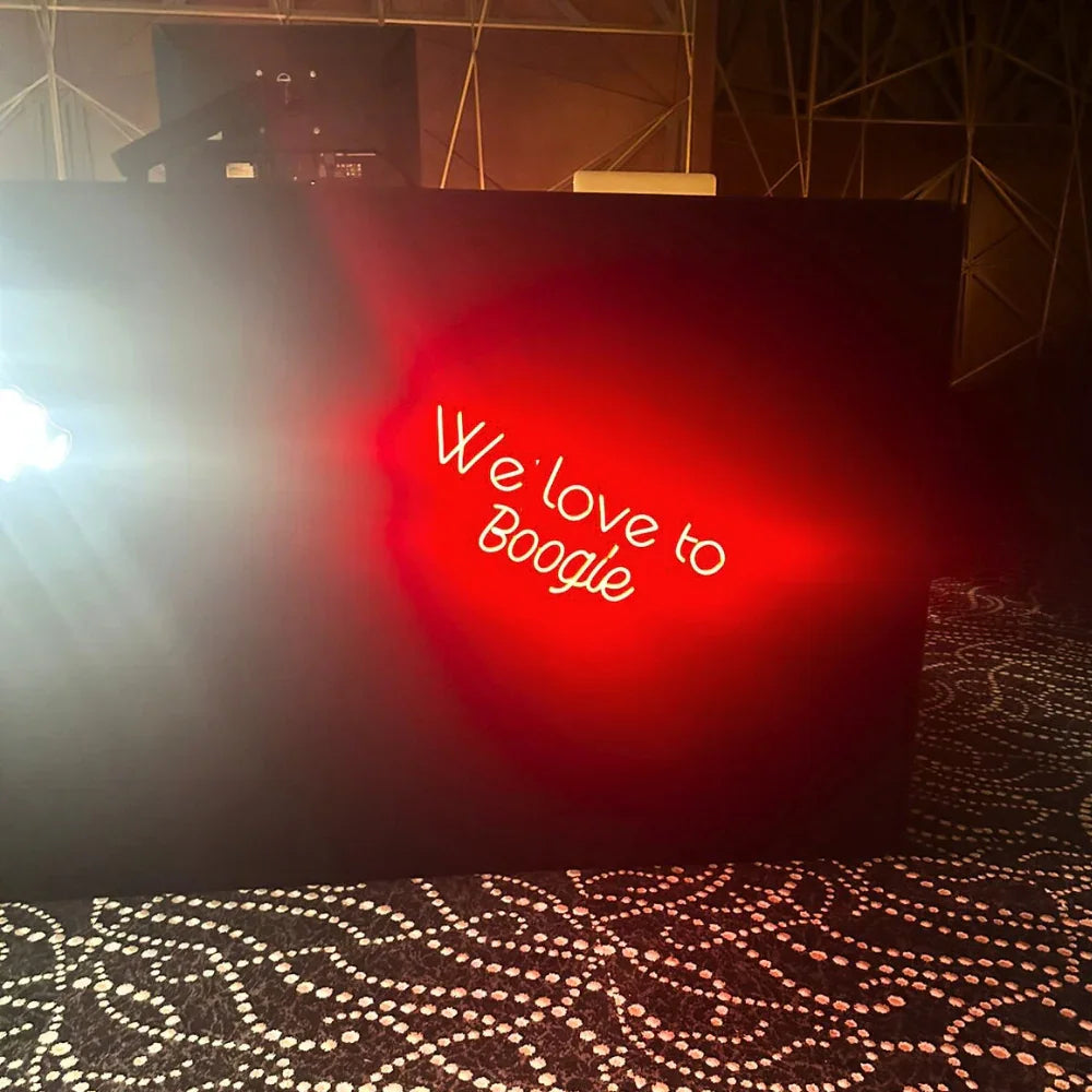 We Love To Boogie-LED Neon Sign, perfect for enhancing party atmospheres with vibrant light; requires electric connection for use.