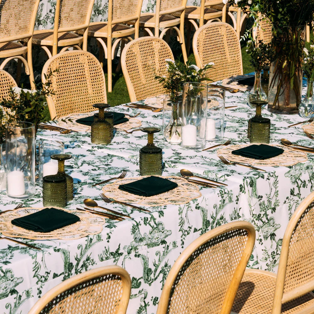 GREEN VINE RECTANGULAR TABLECLOTH elegantly draped on a dinner party table, surrounded by glassware and floral centerpieces, enhancing the dining setup for a special occasion.