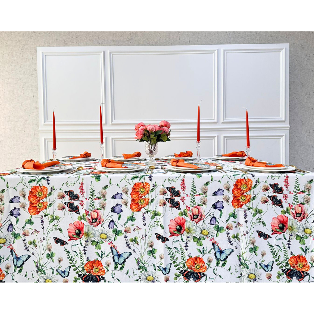 BUTTERFLY MEADOWS RECTANGULAR TABLECLOTH elegantly displayed on a table set with flowers and candles, enhancing a premium dining experience.