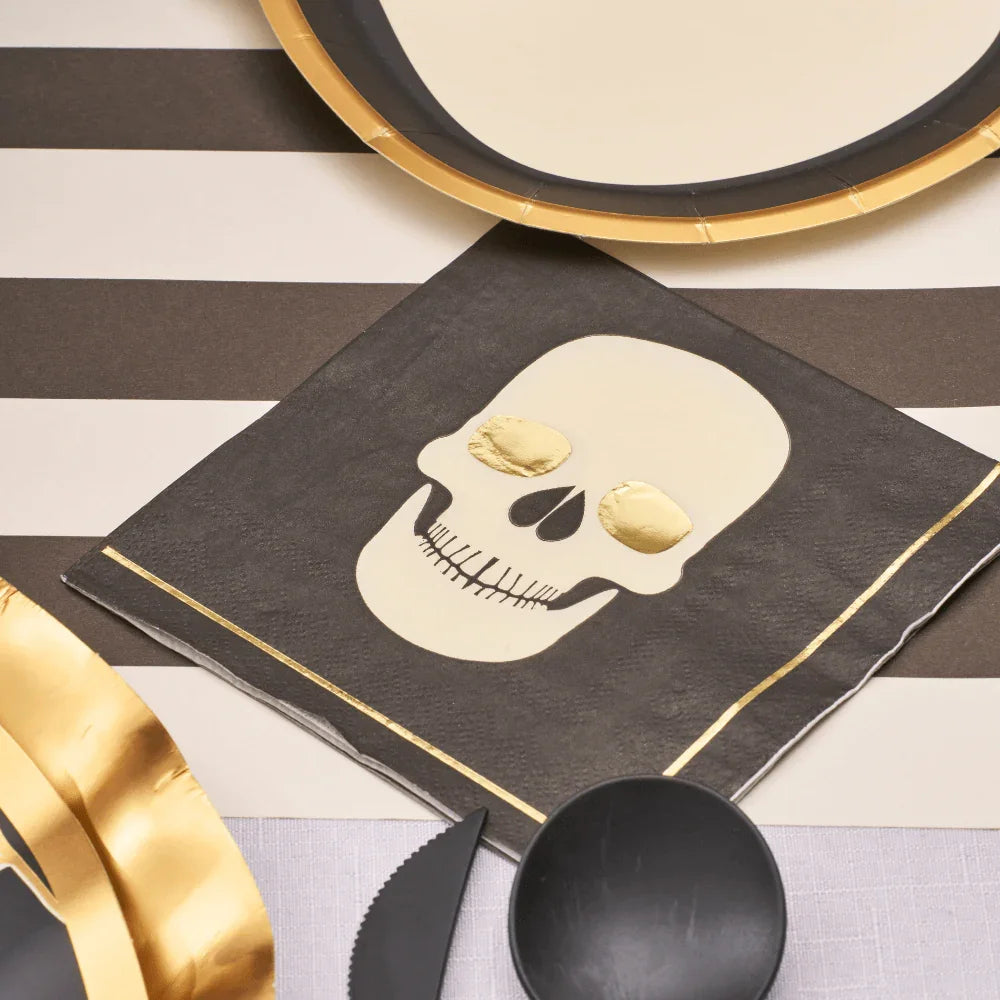 Classic Spooky Skull Cocktail Napkins set on a stylish black and gold table, perfect for enhancing Halloween-themed gatherings.