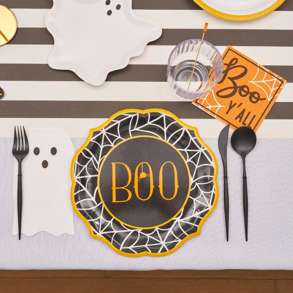 Bella Plastic Cutlery in Black displayed on a decorated table with black and white tableware, emphasizing its sleek, modern design suitable for events.