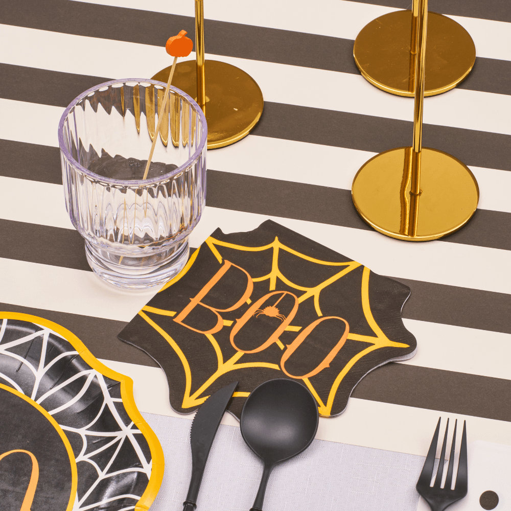 Boo Treats Spiderweb Luncheon Napkins featured on a table set for a Halloween gathering, showcasing their spiderweb design. Perfect for enhancing your spooky table setting.