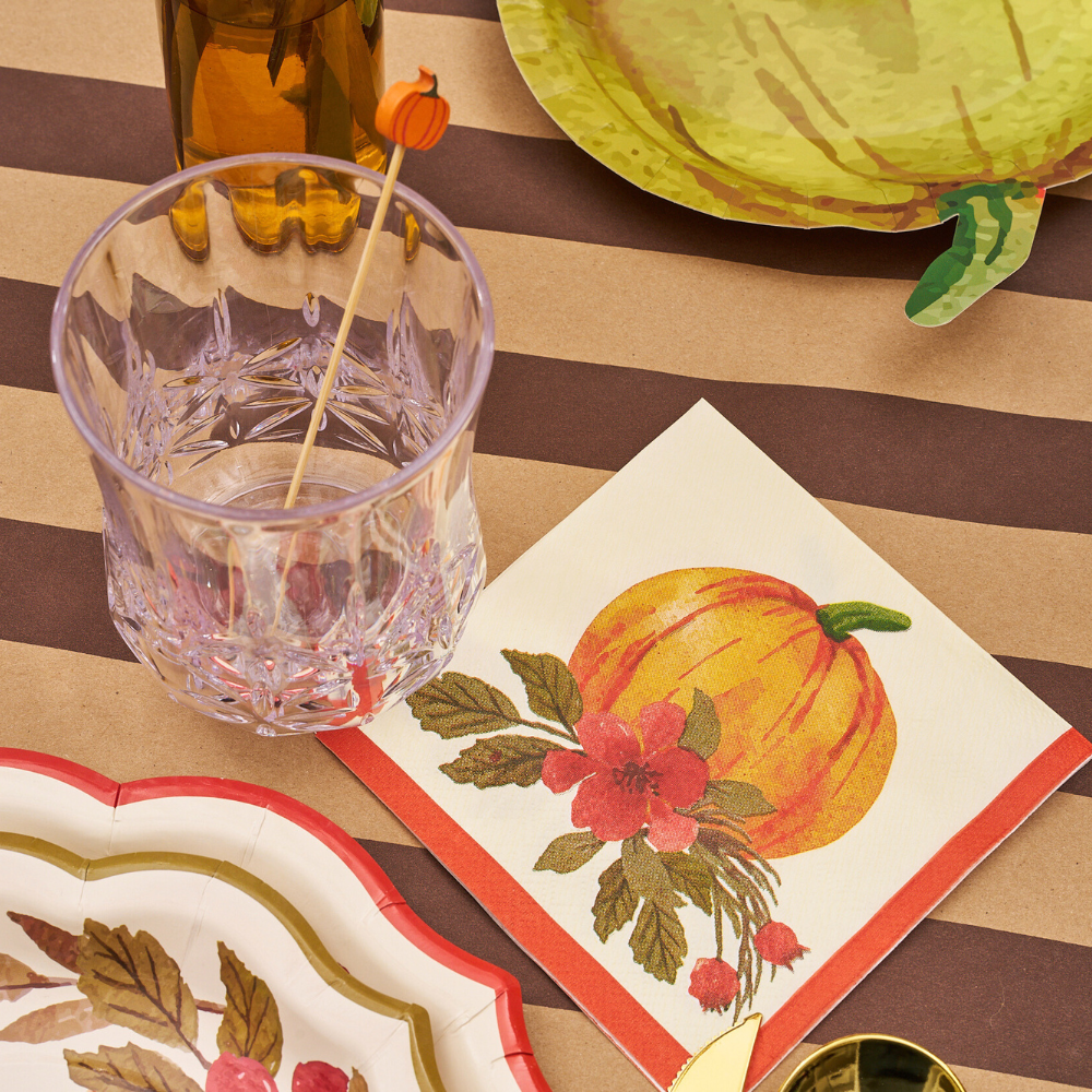 Autumn Foliage Cocktail Napkins on a table, enhancing a festive setting with plates and glasses; perfect for party decor.
