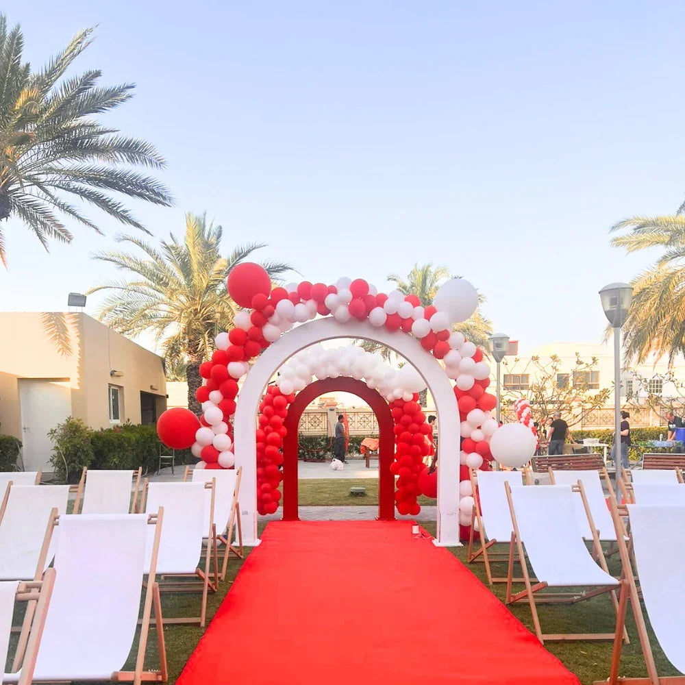 U-Shaped Balloon Arch setup on a red carpet with white chairs, ideal for events like graduations and birthdays.