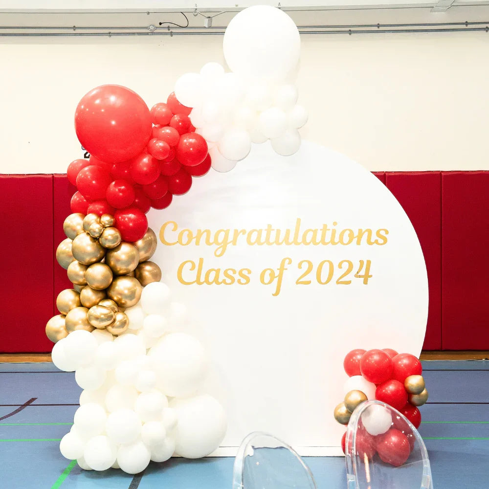 Round Wood Balloon Backdrop featuring a white and red balloon arch with gold text, perfect for enhancing any celebration with customizable balloon arrangements.