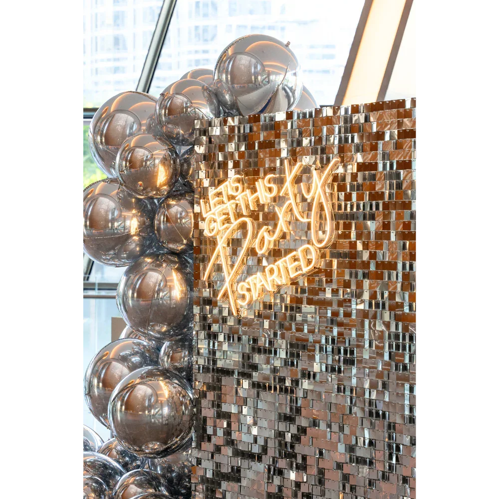 Silver Sequin Wall Balloon Backdrop with LED Neon Sign and silver balloons, ideal for weddings, birthdays, or special events.