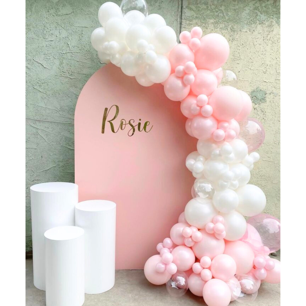 Wood Curved w/ Podiums Balloon Backdrop featuring a pink and white balloon arch, ideal for enhancing party settings like birthdays or baby showers.