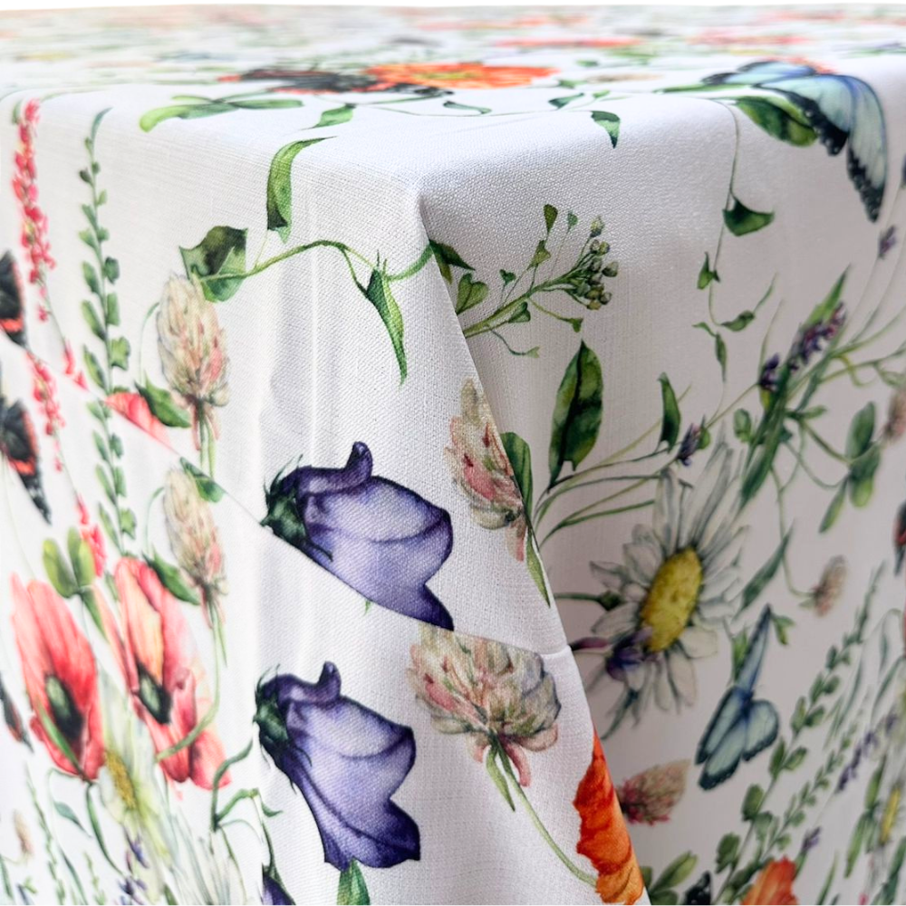BUTTERFLY MEADOWS RECTANGULAR TABLECLOTH featuring embroidered floral patterns, perfect for enhancing any dining setting with elegance. Ideal for events or special occasions.
