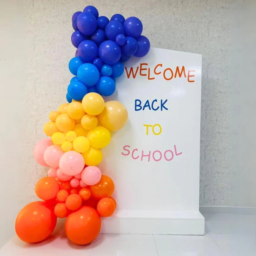 Angled Wall Balloon Backdrop for events, featuring various balloons next to a sign; ideal for celebrations like birthdays or showers, customizable for any occasion.