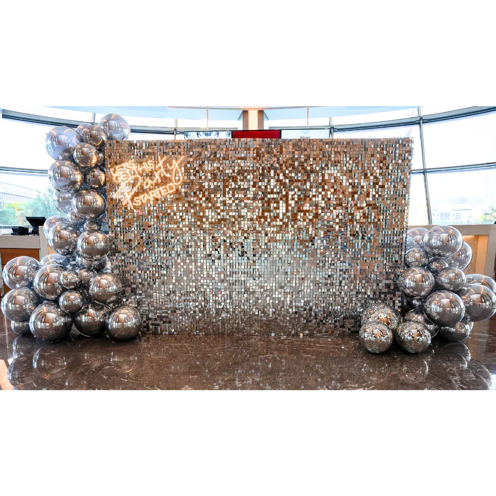 Silver Sequin Wall Balloon Backdrop with LED Neon Sign, featuring silver balloon decorations; ideal for elegant events like weddings and parties.