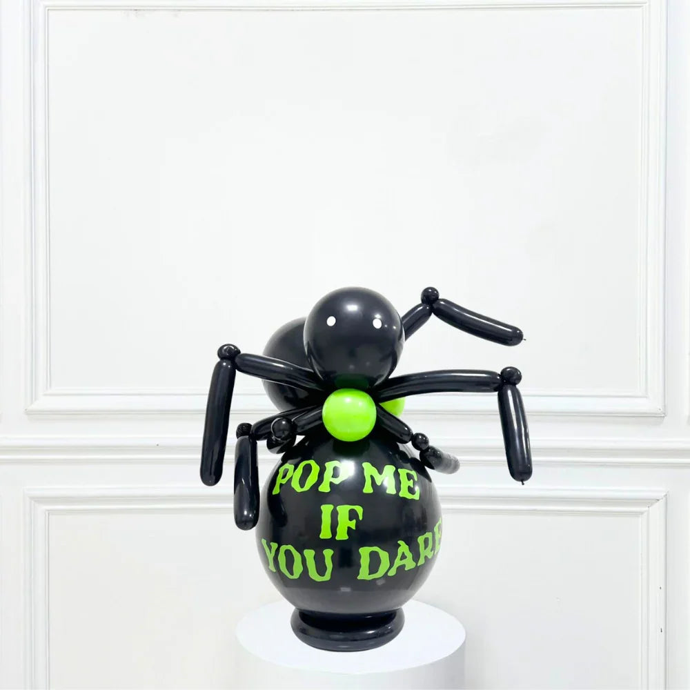 Black Spider Balloon Stack featuring a black balloon spider with green and yellow text, perfect for Halloween parties as a floor-standing or table decoration.