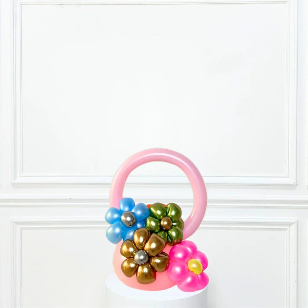 Pink Flower Basket: A balloon arrangement shaped like a flower, perfect for adding a playful touch to any event or as a unique gift accessory.