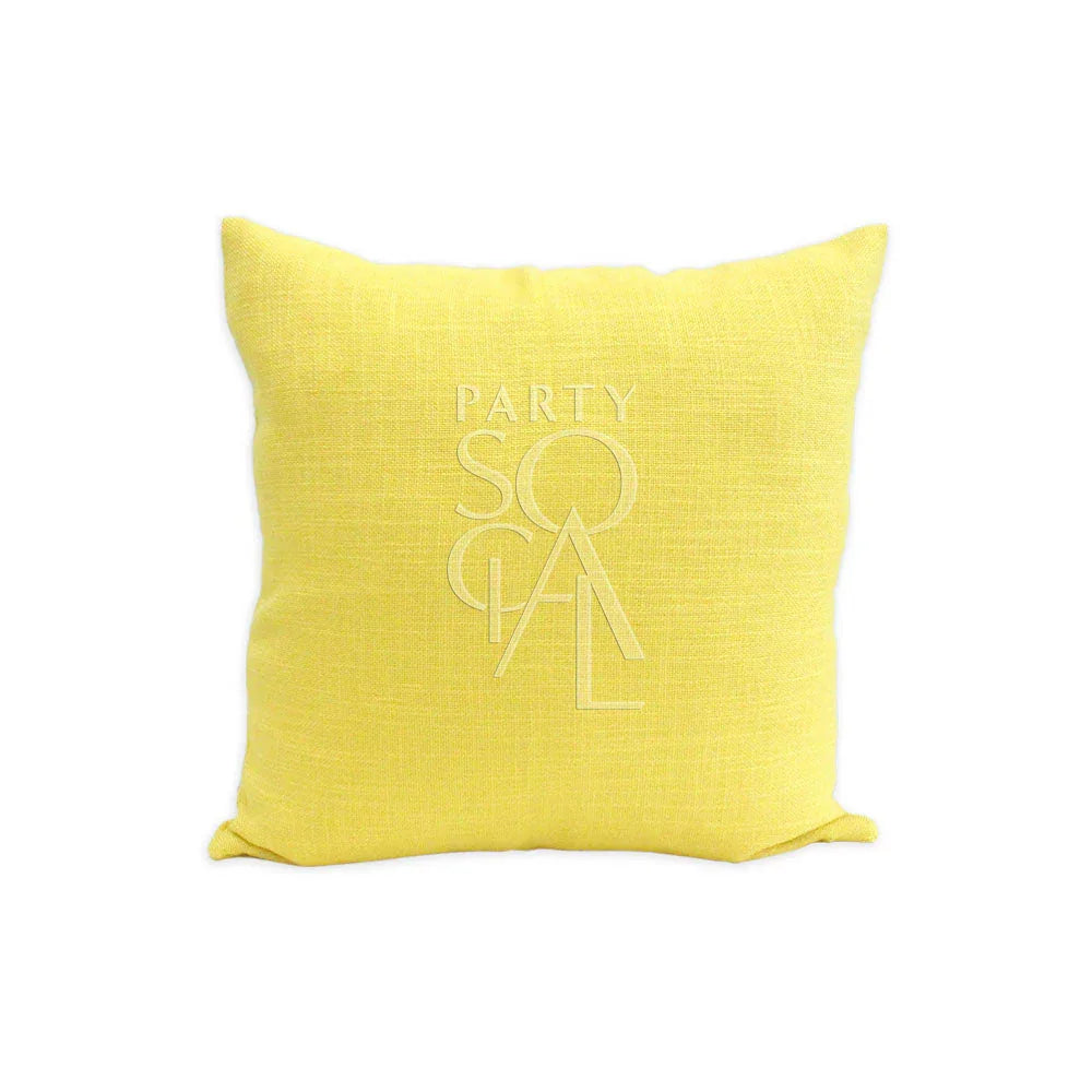 CUSHION COVER LINEN BLEND featuring a white logo on a yellow pillow, suitable for event decor from Party Social.