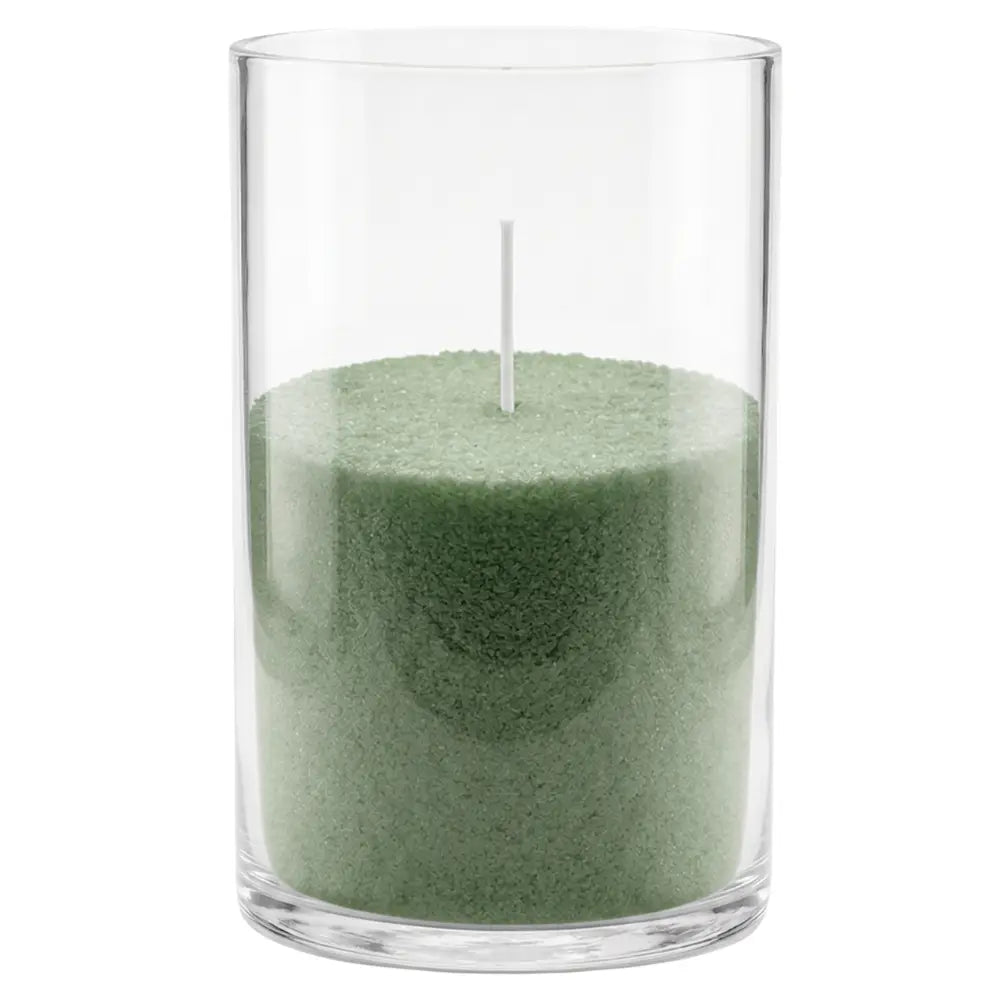 A green wax candle in a clear cylindrical glass container with a single white wick, shown against a plain white background.