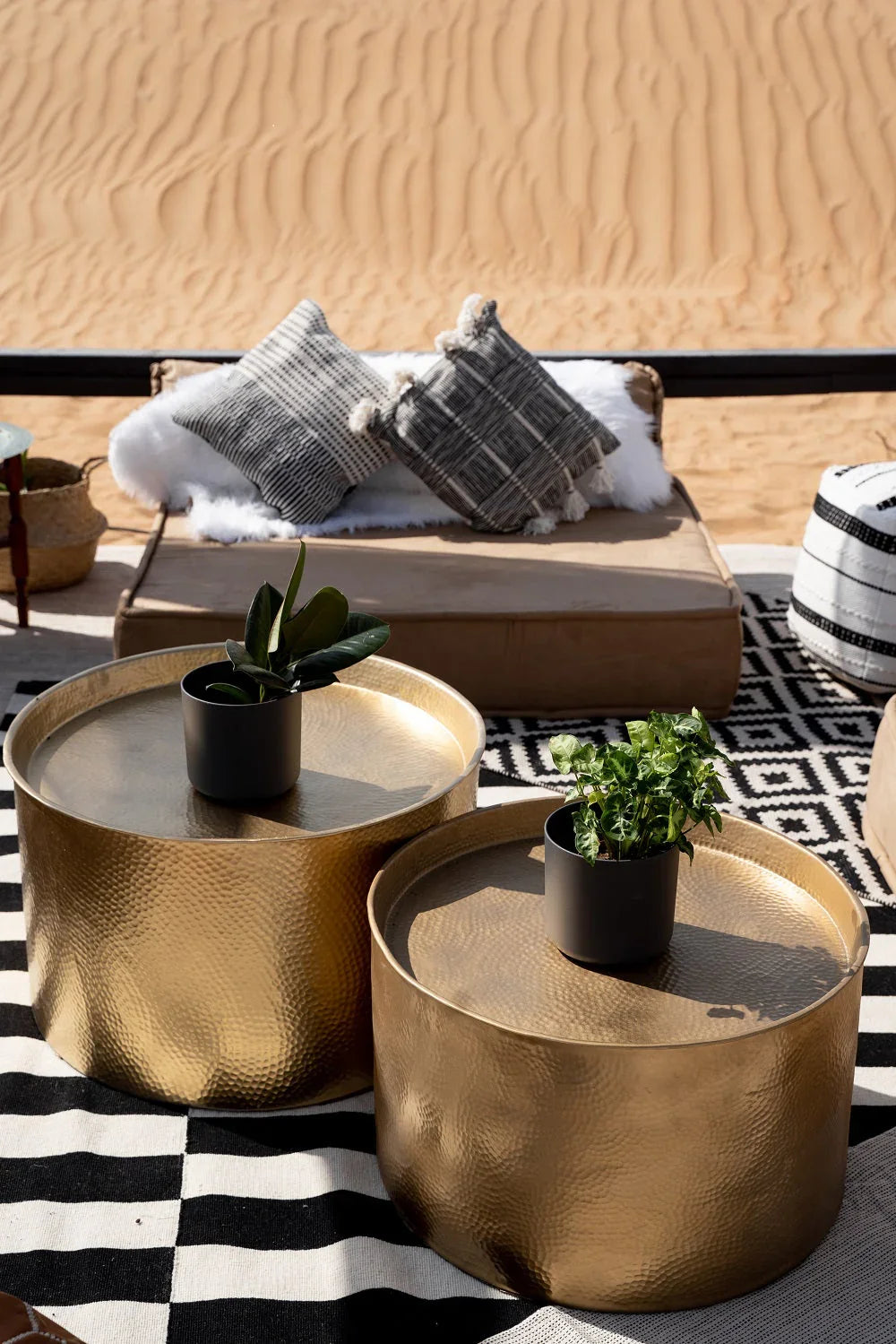 CUSHION BOHO COVER displayed on a rug, surrounded by pillows and decorative items like potted plants and gold tables, ideal for event styling.