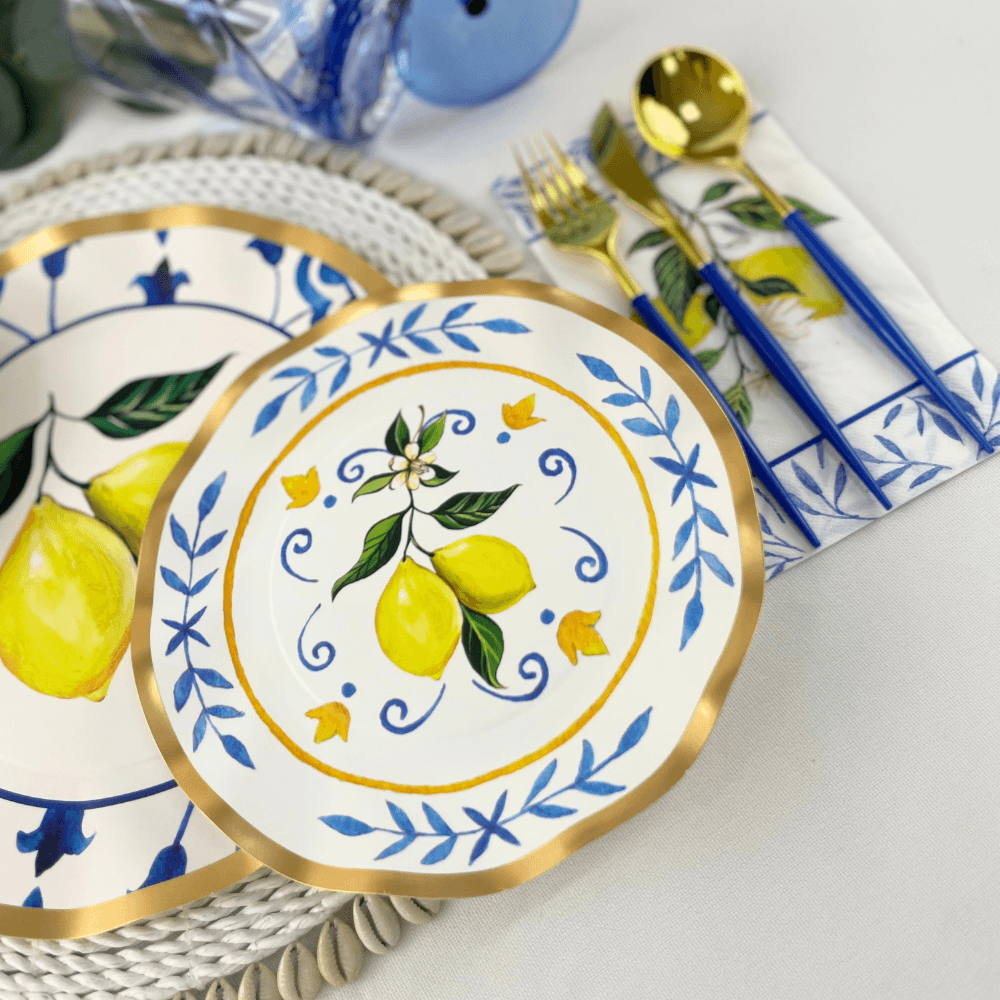 Capri Coast Paper Salad & Dessert Plate featuring ruffled foil edge, intricate blue pattern, and lemons on white background. Adds elegance to events.