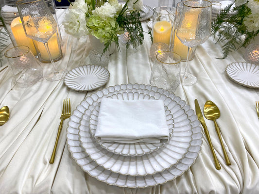 Classic Cream-Dining Setup for 8 guests featuring white scalloped plates, gold cutlery, crystal glassware, and elegant floral centerpieces on an ivory tablecloth.