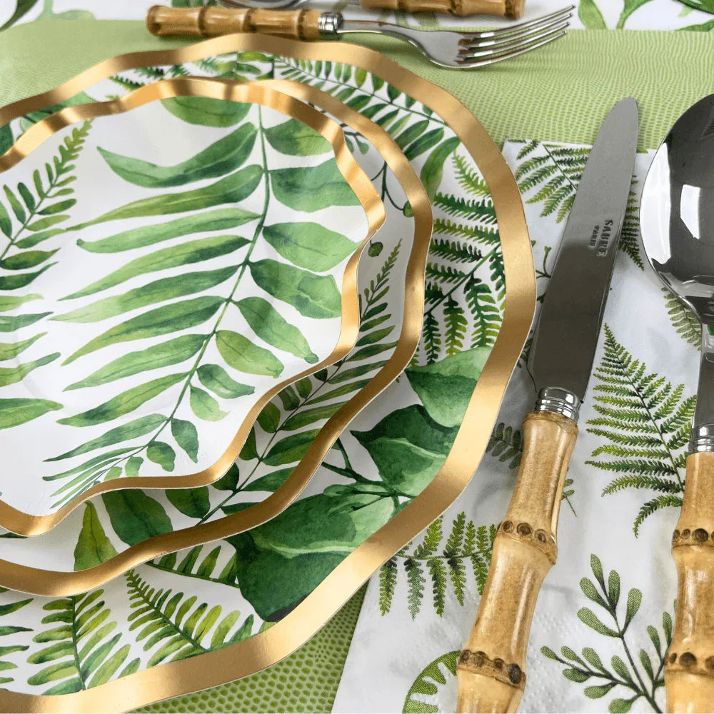 Fern & Foliage Paper Appetizer & Dessert Bowl-8 Per Package displayed with utensils and plates. Elegant green fern design with gold foil trim for stylish events.
