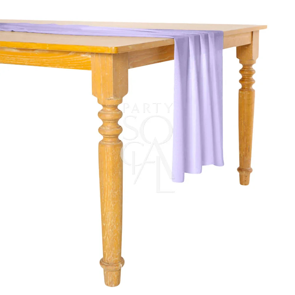 Chiffon Table Runner displayed on a table, showcasing its elegant drape. Ideal for enhancing party decor with a touch of sophistication.