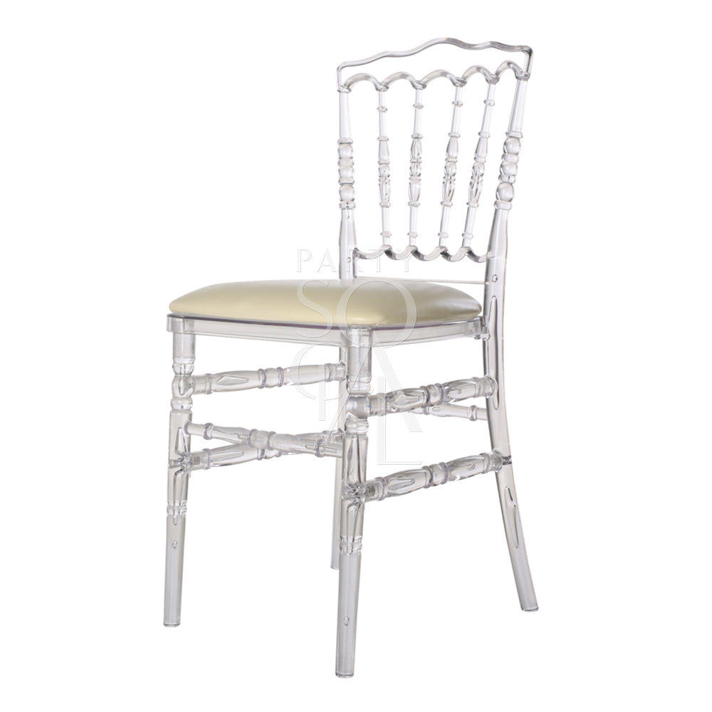 NAPOLEON ACRYLIC CHAIR: A clear plastic chair with a tan cushion, ideal for weddings and events, featuring classic armless design suitable for various occasions.