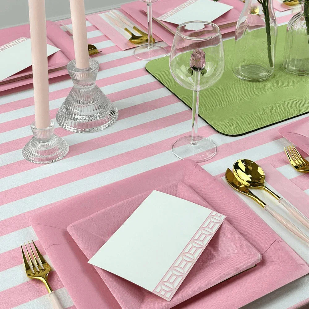 Pink Stripe Linen Tablecloth on a table, adorned with pink and green plates, glasses, and silverware, showcasing elegant tableware for special occasions.