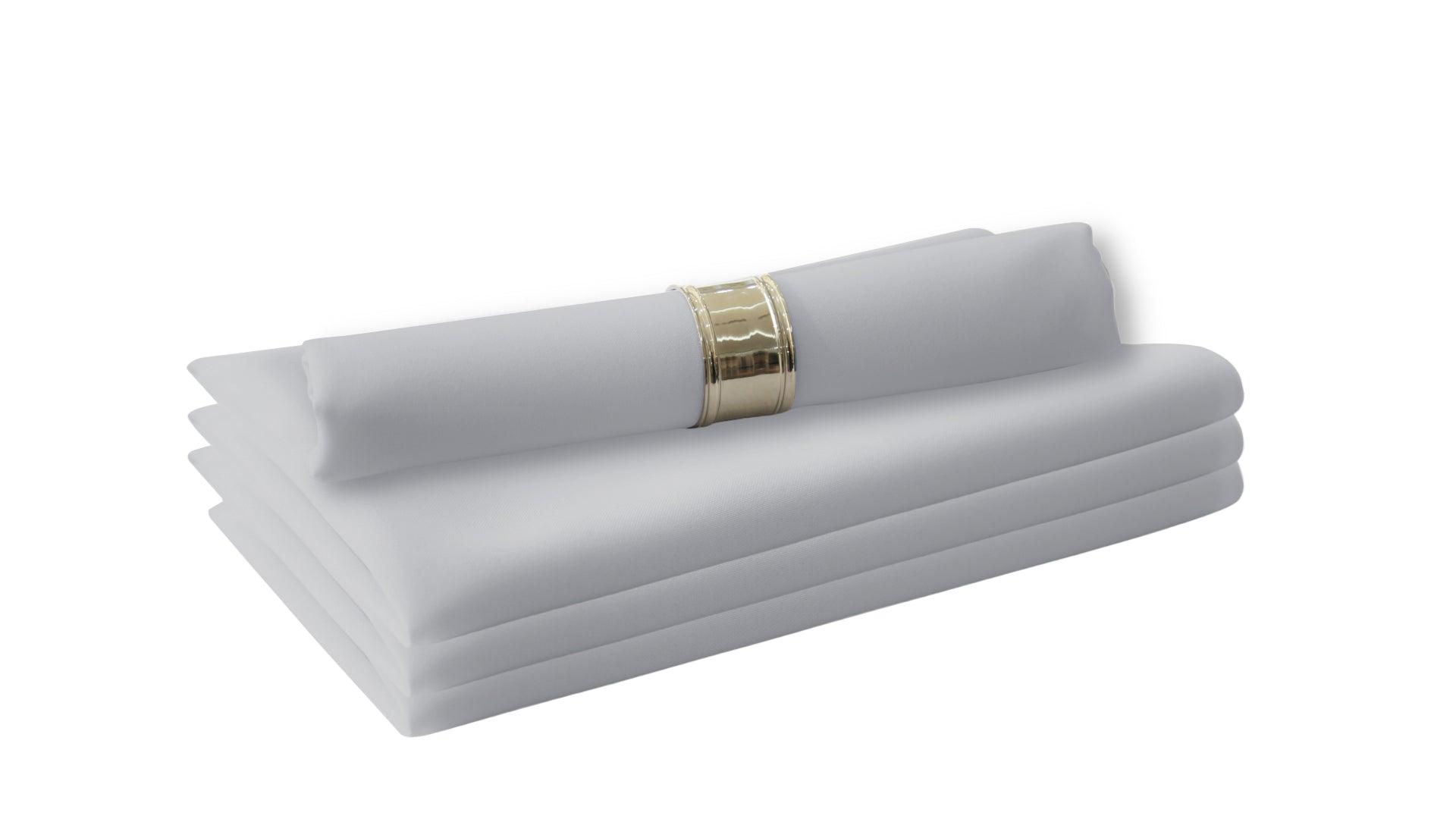 A stack of folded white polycotton napkins, perfect for livening up your dinner table. Easy to wash and reuse, they are a staple in your dining table linens. 4 per pack.
