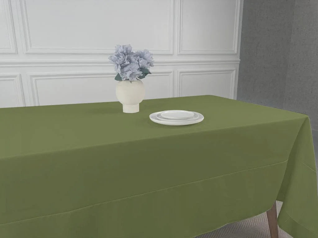 A Polycotton Tablecloth with a vase of flowers as a centerpiece on a table.
