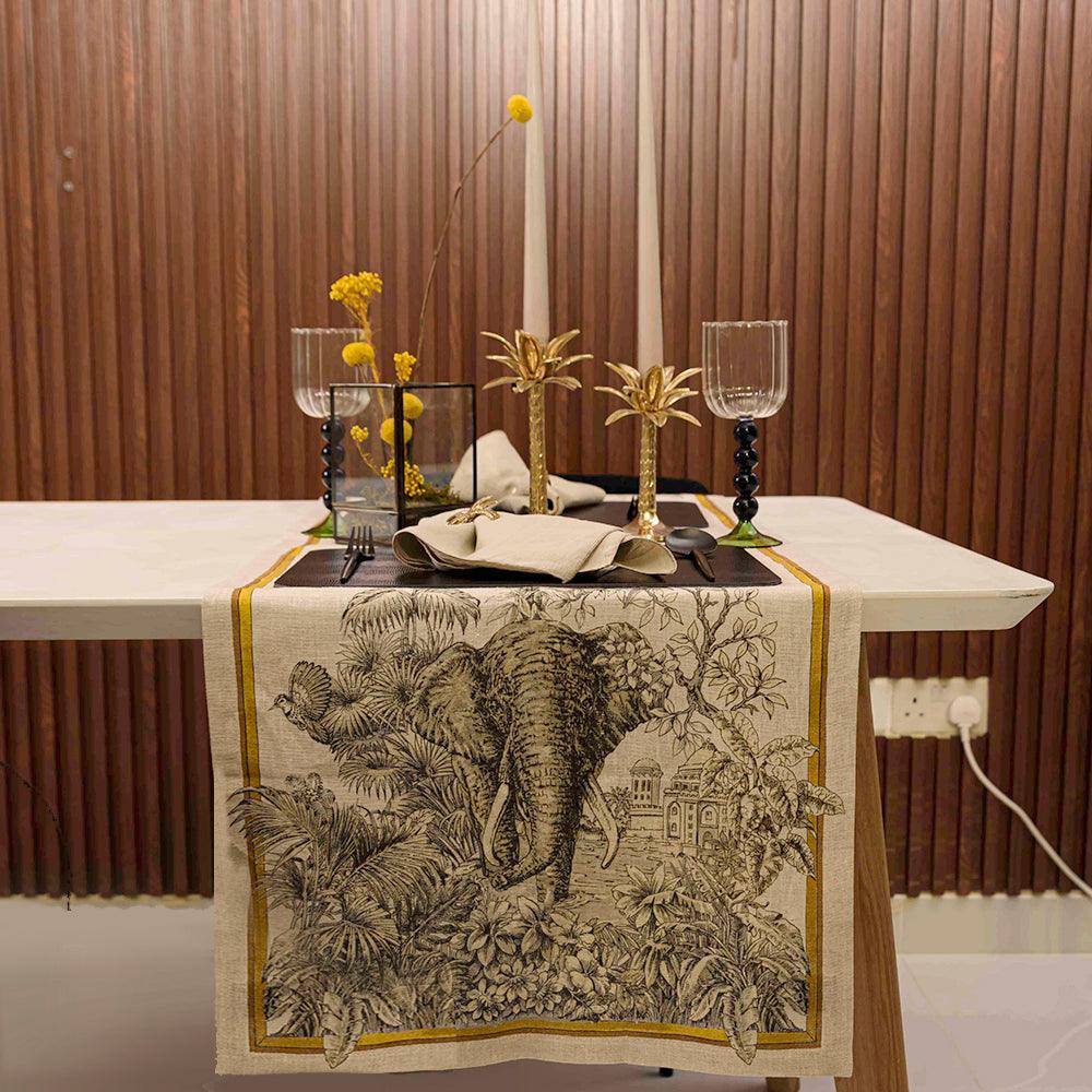 Tantra Pure Linen Runner on table with towel, glasses, and decor.