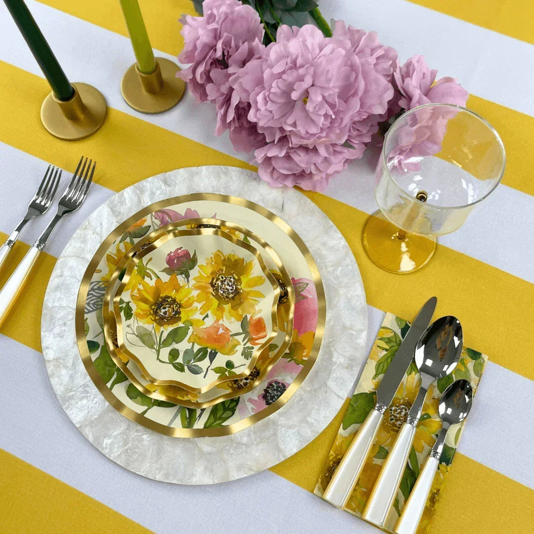 Alt text: Pearl Cutlery Set of 5, alongside floral plates and flowers, elegantly set on a table, perfect for enhancing any event setup.