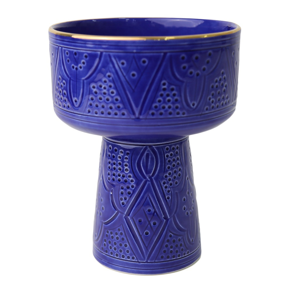 A unique ceramic pedestal bowl with intricate engravings, perfect for adding elegance to your home.